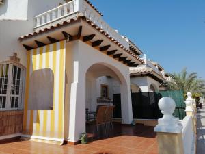 a house with a colorful gazebo at Luxury and comfort in La Marina, with sea views at El Pinet beach in La Marina