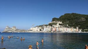 a group of people in the water at a beach at La casa con vista di Emma in Vezzano Ligure