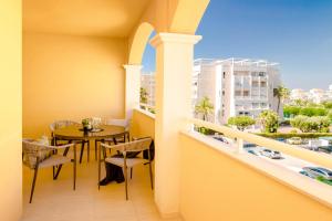 a balcony with a table and chairs and a view of a city at Espanatour TORREMAR in La Mata