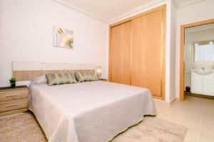 a bedroom with a large bed and a bathroom at Espanatour TORREMAR in La Mata +15 photos