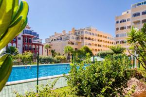 a view of a swimming pool in a city with buildings at Espanatour TORREMAR in La Mata