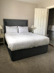 a bed with white sheets and pillows in a bedroom at Sli Na Mara in Galway