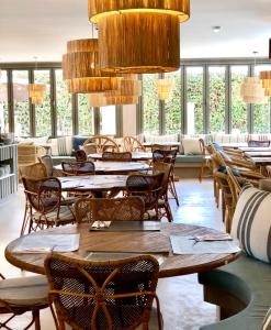 a restaurant with wooden tables and chairs and windows at Soho Boutique Las Vegas in Málaga