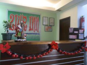 a room with a christmas garland on a desk at ZIUR INN in Laoag