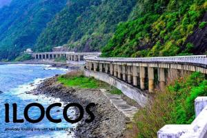 a bridge over a river next to a mountain at ZIUR INN in Laoag +30 photos