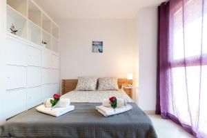 a bedroom with a large bed with two pillows at Stay Barcelona Sant Martí in Barcelona