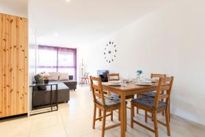 a dining room and living room with a table and chairs at Stay Barcelona Sant Martí in Barcelona