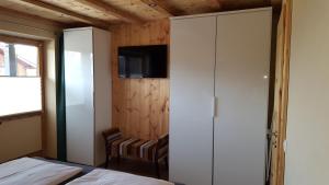 a bedroom with a bed and a closet and a tv at Ferienwohnung Zirbenduft in Inzell