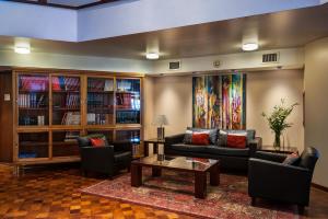 a living room with couches and a coffee table at Hotel de la Cañada in Córdoba