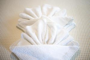 a pile of white towels sitting on a table at Kokkinos in Vourvourou