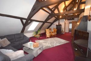 a living room with a couch and a table at Alte Rentei in Schleiden