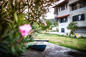 a house with a yard with a pot with a sign that says team market at Kokkinos in Vourvourou