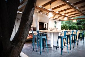 a kitchen with blue stools and a large table at Kokkinos in Vourvourou