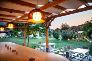 a table and chairs under a pavilion with a playground at Kokkinos in Vourvourou