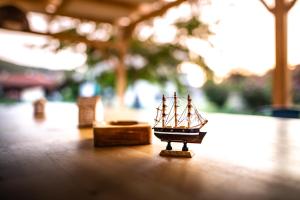 a small toy ship sitting on a table at Kokkinos in Vourvourou