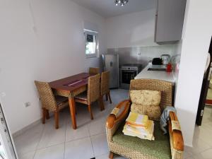 a kitchen with a table and chairs and a dining room at Apartments Rales in Sveti Stefan +48 photos