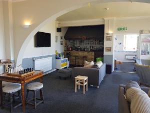 a living room with a couch and a table at Victoria Lodge in Shanklin