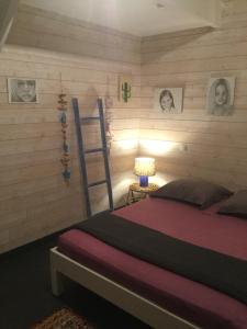 1 dormitorio con cama, escalera y cuadros en la pared en Villa Shenandoah, en Sainte-Anne