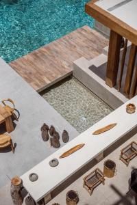 a view of a pool with a table and water at The Syntopia Hotel - Adults Only in Adelianos Kampos