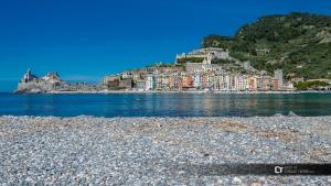 um grupo de edifícios numa colina junto à água em Belle Cinque Terre Apartments em La Spezia