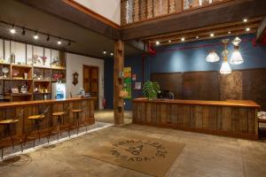 a bar in a restaurant with stools and a counter at Pousada Armazém 26 in Tiradentes