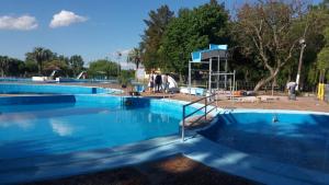 a group of three swimming pools in a park at Cabañas en Termas de Guaviyú, Paysandú, Uruguay in Quebracho
