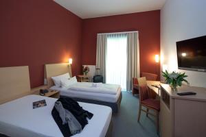 Postel nebo postele na pokoji v ubytování Hotel Mainpromenade ***S