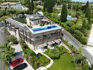 an aerial view of a mansion with a swimming pool at Lamasu RioVerde - Lago di Garda in San Felice del Benaco