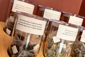a group of glass jars filled with herbs at Lamasu RioVerde - Lago di Garda in San Felice del Benaco
