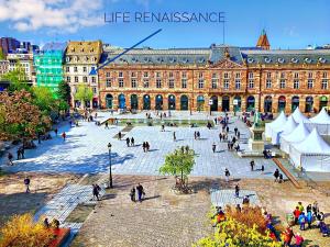 a group of people walking around a large building at LIFE RENAISSANCE - New Concept - Place Kléber in Strasbourg