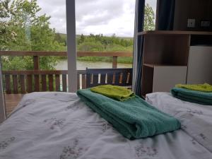 a bedroom with two beds and a large window at Hagi 1 Guesthouse in Aðaldalur