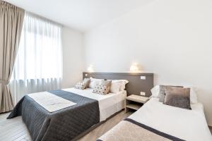 1 dormitorio con 2 camas y ventana en Cinque Terre Bridge, en La Spezia