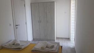 a room with two towels on a table with a door at Bonaca Apartments in Kotor +22 photos