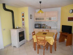 a kitchen with a table and a stove and a dining room at Chalet Migazzi in Cogolo +31 photos