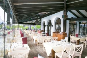 a dining room with white tables and chairs at Hotel LIVVO Volcán Lanzarote in Playa Blanca