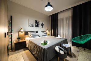 a bedroom with a bed and a table and chairs at Nordik Rooms Urban - Trinidad "Copenhague" in Málaga