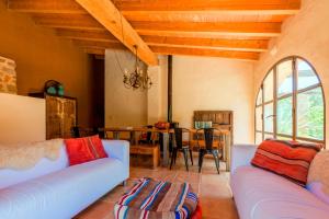 a living room with two couches and a dining room at Casa Rural Refugio Marnes in Benissa