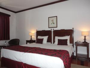 Een bed of bedden in een kamer bij Hotel Rural Quinta de Santo Antonio