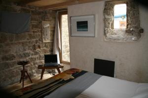 a bedroom with a bed and a laptop on a table at Le Magasin à Sel in Crozon