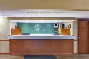 a lobby of an american inn with a sign on the wall at AmericInn by Wyndham Hutchinson in Hutchinson +115 photos