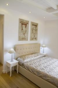 a bedroom with a large bed with two lamps at B&B Chez Moi Lame 57 in Bologna