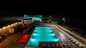 a swimming pool at night with a building at Complex Noblesse in Vaslui