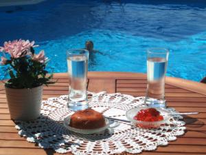 a table with a plate of food and glasses of water at Scorpios Hotel & Suites in Samos