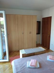a bedroom with two beds and a cabinet with two towels at Soba Željka in Bribir +2 photos