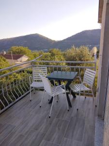 a table and two chairs sitting on a balcony at Soba Željka in Bribir