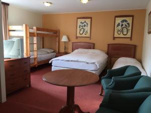a hotel room with two beds and a bunk bed at Hotel Vogar in Vogar