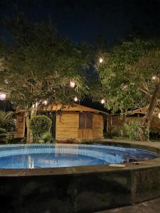 a swimming pool in front of a house at night at Villa Armonia Hotel & Spa in Jocotepec