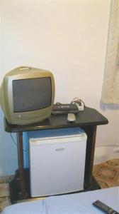 a desk with a tv and a computer on it at Pensión Iglesias in Zaragoza +37 photos