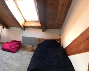 a small room with a bed and a window at Boréales - spacious duplex - in La Grave-La Meije heart in La Grave