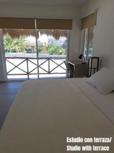 a bedroom with a bed with a view of a balcony at Casa Kay in Playa del Carmen